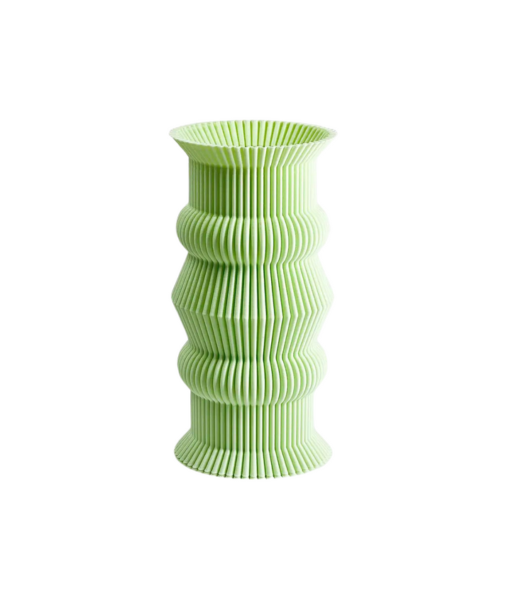 Vista frontale di un vaso verde lime alto e stretto, con una serie di curve e righe che ne definiscono la forma scultorea.