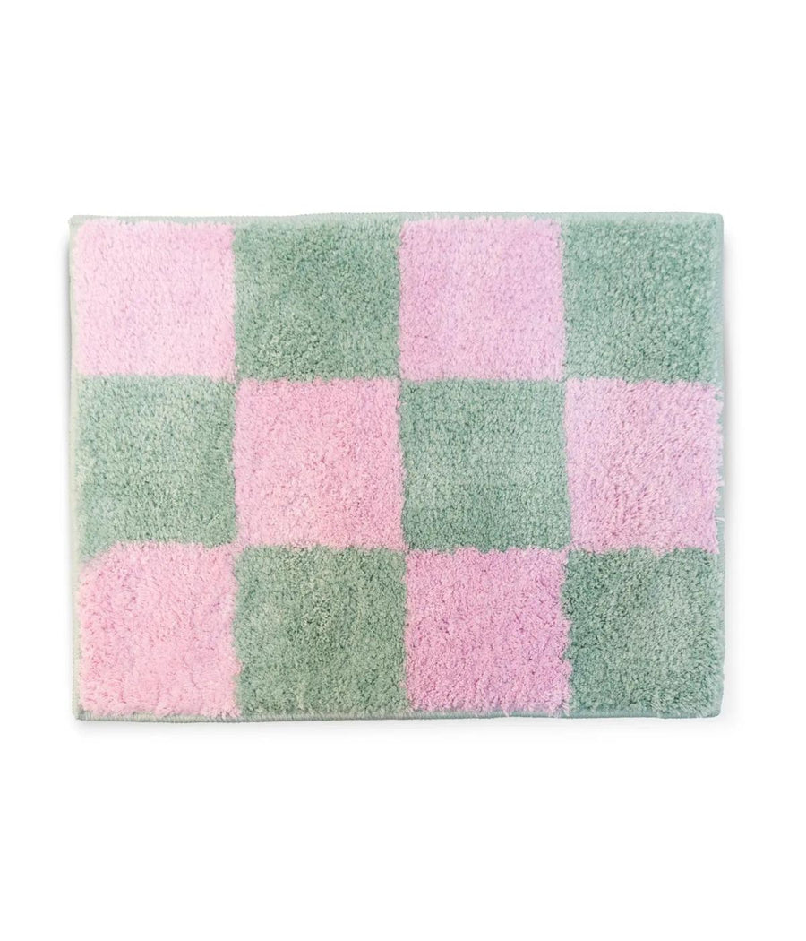 Tappeto da bagno soffice con motivo a quadretti in toni di rosa e verde, offrendo un aspetto accogliente e colorato per l'arredo del bagno.
